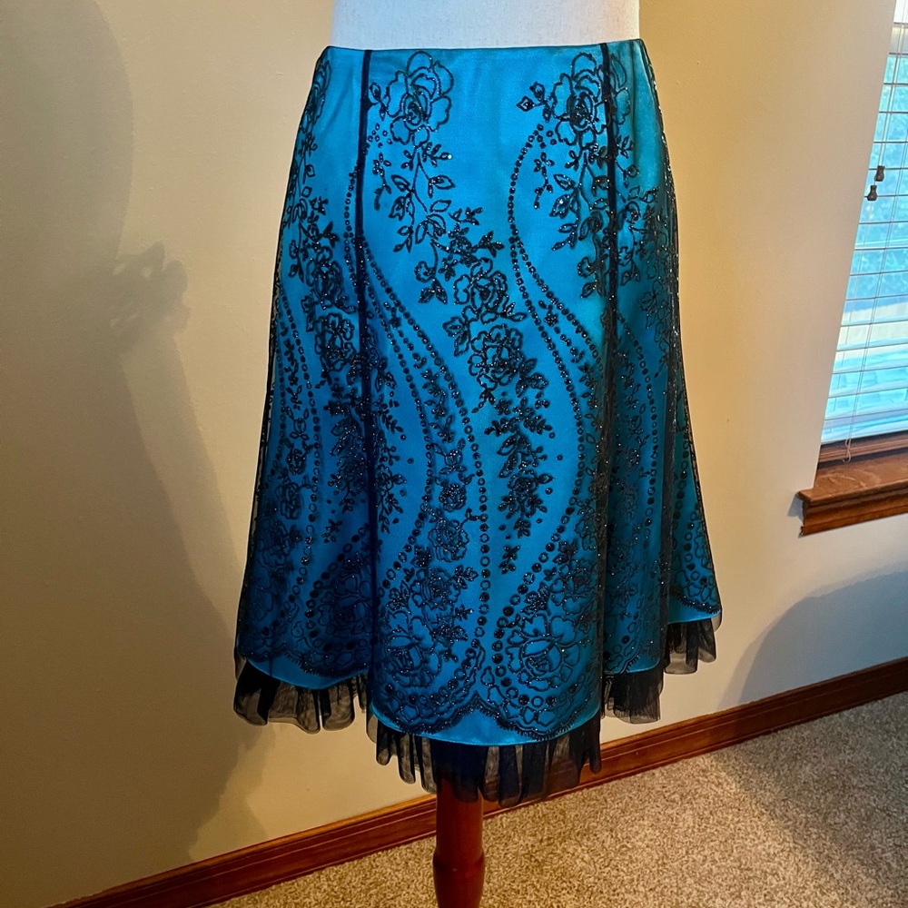 Dressy skirt with embroidered black net over a shimmery turquoise skirt.